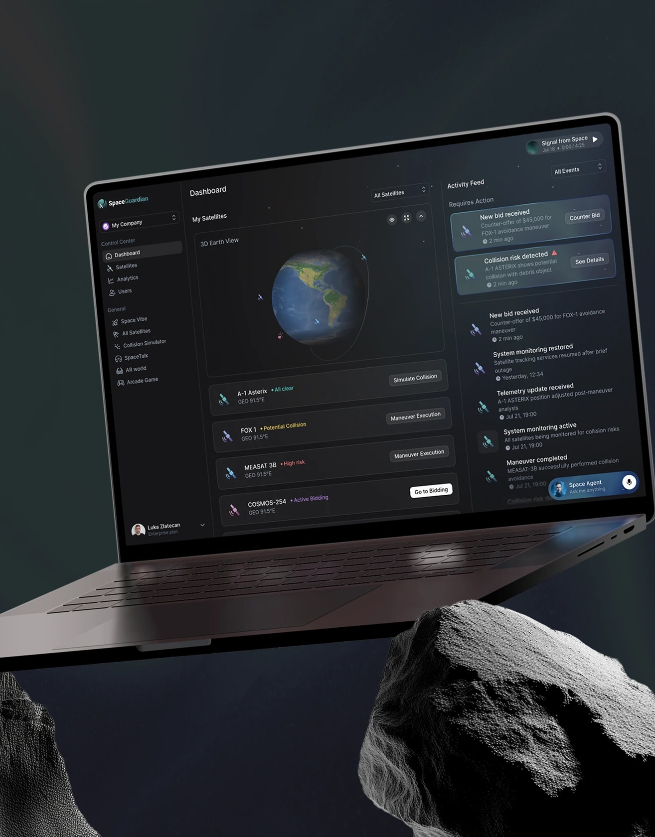 The Space Guardian dashboard on a laptop, showing the tracked satellite list beside an activity feed